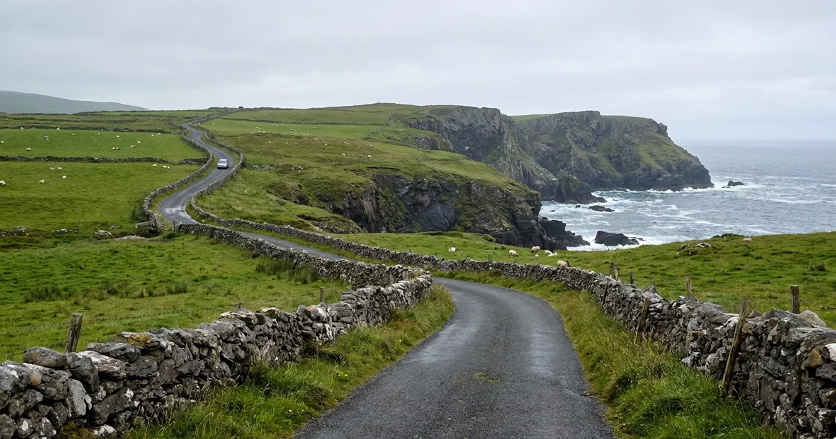 Summer road along Ireland's west coast with cliffs, green fields and Atlantic light